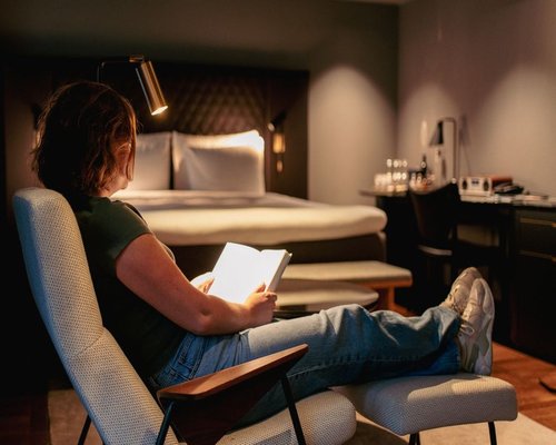 person reading a book in a comfortable room